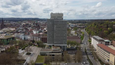 Kaiserslautern-aerial-cityscape-with-street-traffic,-municipality-city-hall-and-shopping-mall-view,-Germany