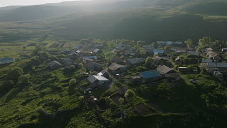 Bird's-eye-down-shot-of-a-peaceful-village-slowly-waking-up-into-a-new-day