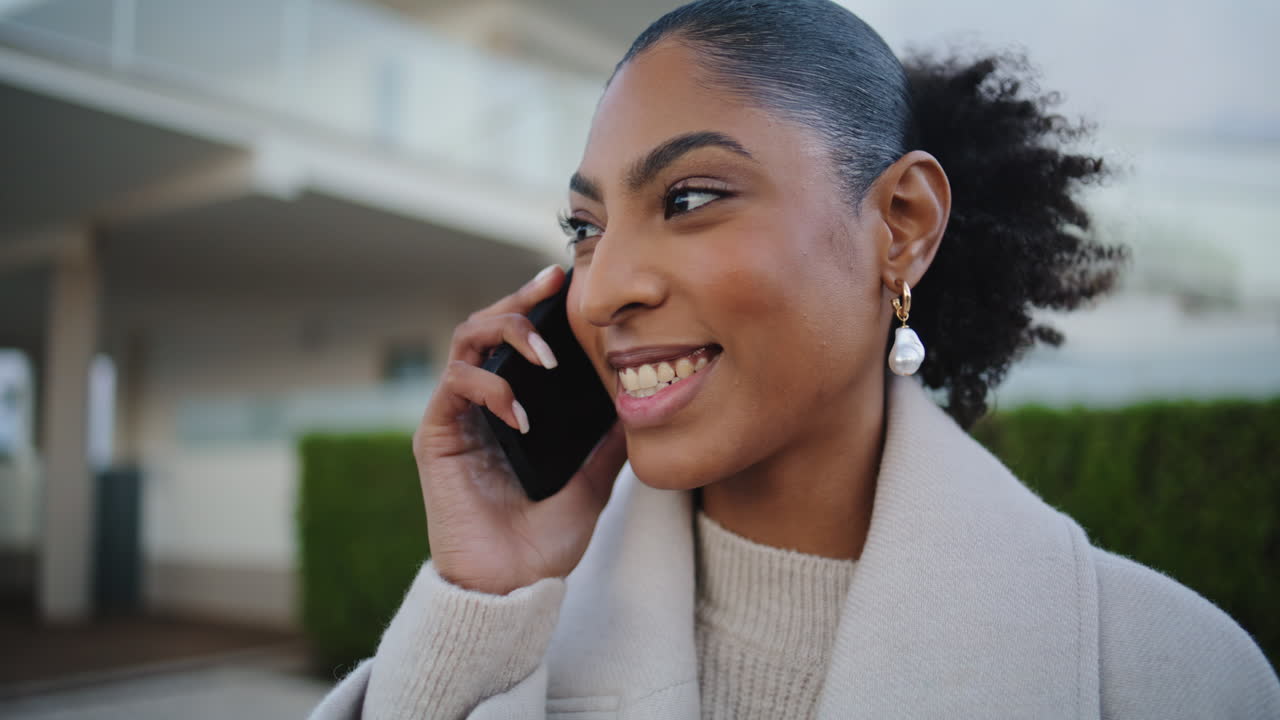 Cheerful woman talking cell sharing good news closeup. Happy african american