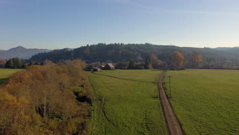 aerial flying towards farmhouse in myrtle point on warm and sunny afternoon