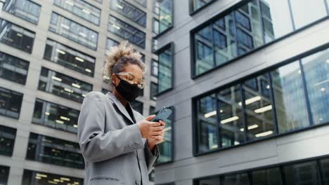 businesswoman using smartphone in city