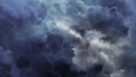 a thunderstorm inside the dark cumulus cloud with flashes of lightning shooting up