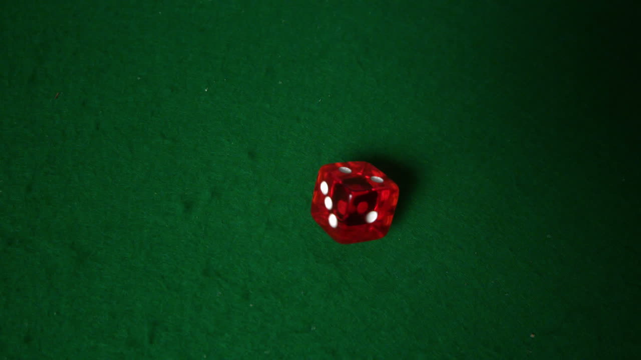 Red dice falling on casino table