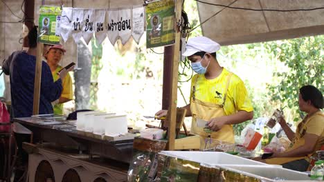 workers serving food at an outdoor stall