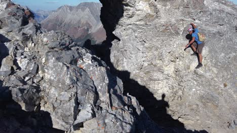 Hiker-carefully-walking-down-steep-rock-Kananaskis-Alberta-Canada