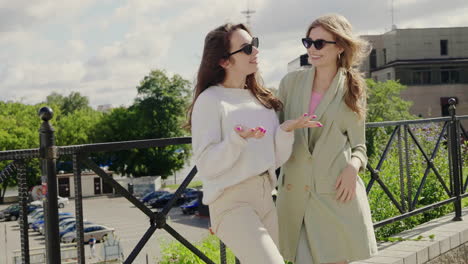 two women talking outdoors