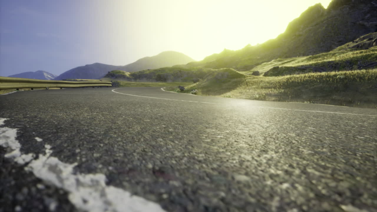 Scenic winding road through mountainous landscape at sunset