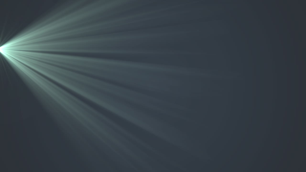 Glowing green rays of light moving against black background