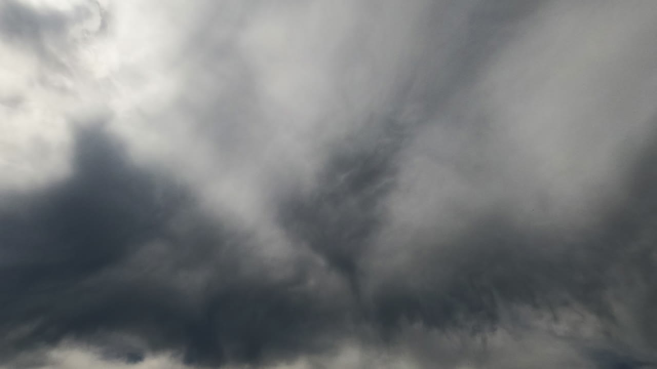 Thick grey cloudscape covering the sky totally. Cumulus clouds spread in the atmosphere. Low angle view timelapse.