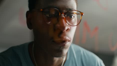 man looking at graffiti through glass