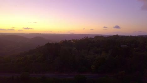 Aerial-view-of-tropical-forest-valley-in-Kondalilla,-Australia-at-sunset