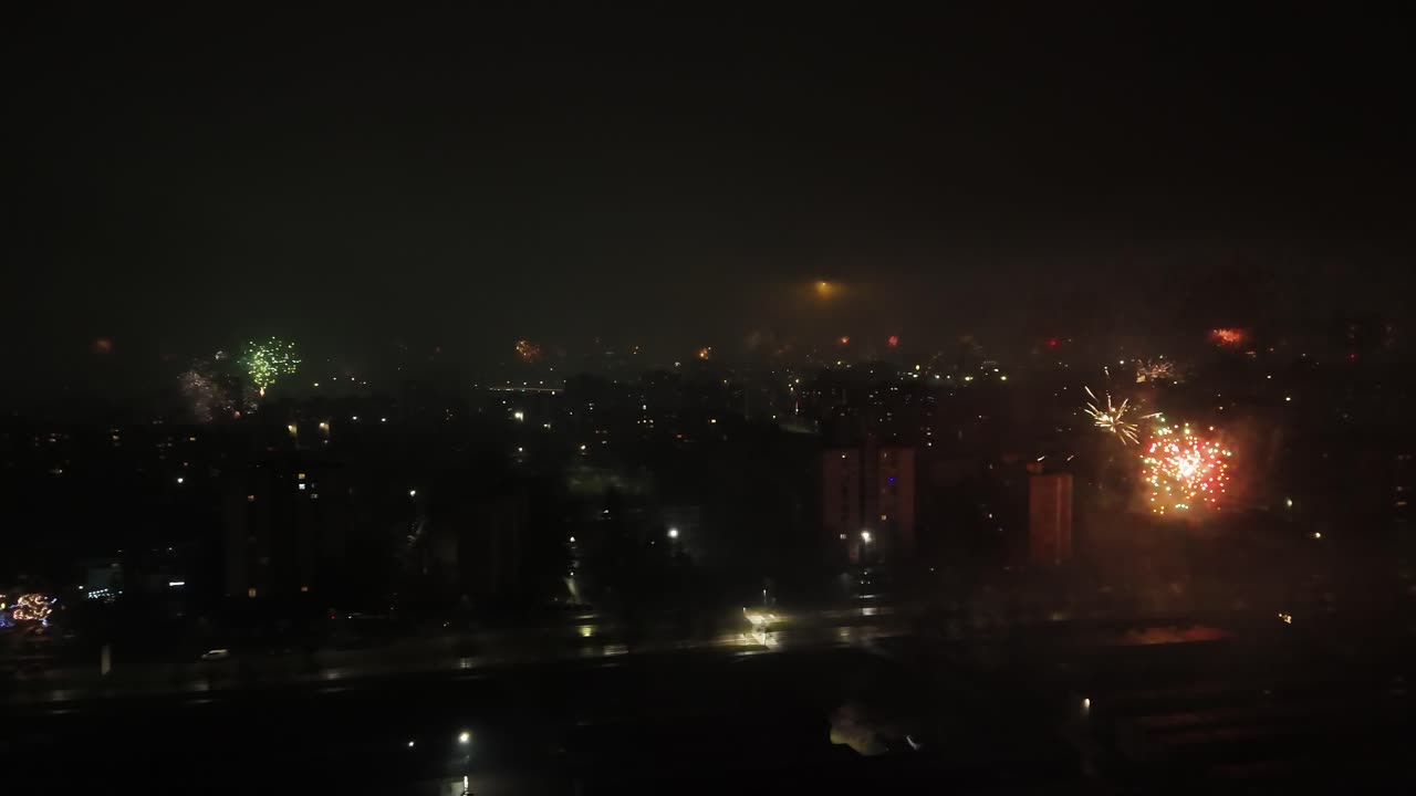 New Year's Eve fireworks show over a European city. Aerial