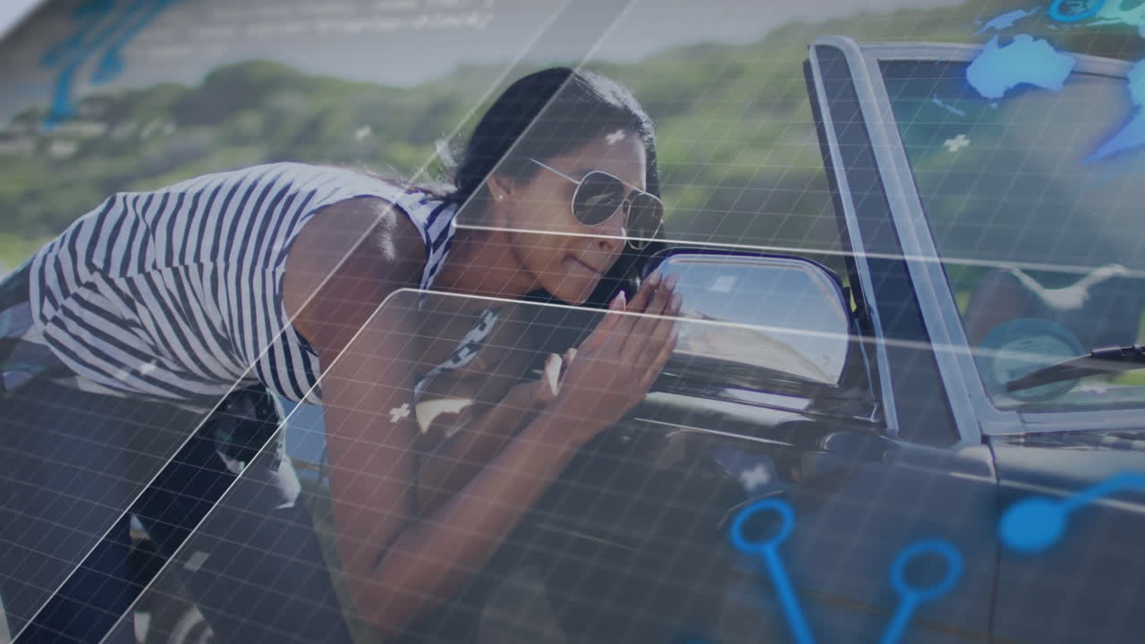Woman leaning over convertible side mirror at roadside, showing technology grid with hologram icons