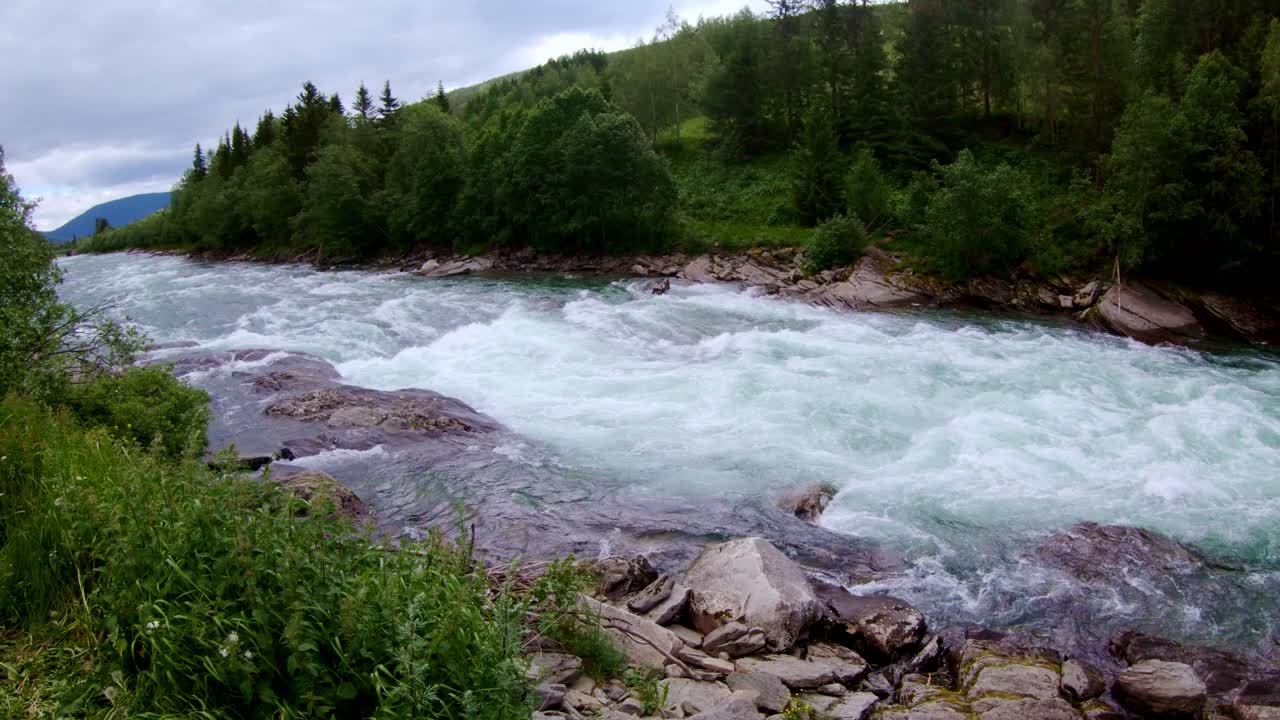 Fast-moving rapids carving through Norwegian valley, wild nature’s beauty, 4K