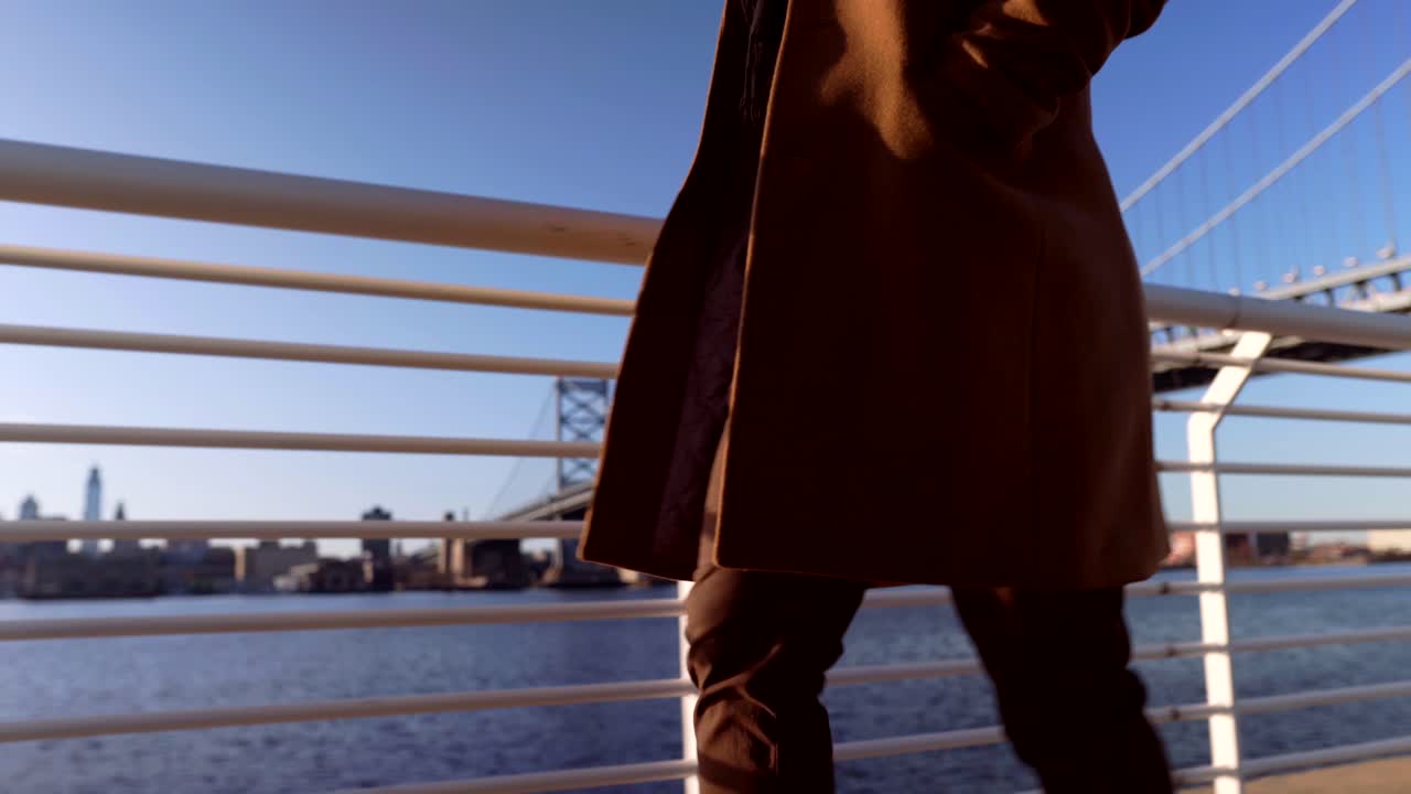 Camden Waterfront Park New Jersey, USA - Asian Korean Handsome Guy Smoothly Walking Alone Along The Pavement - Wide Shot