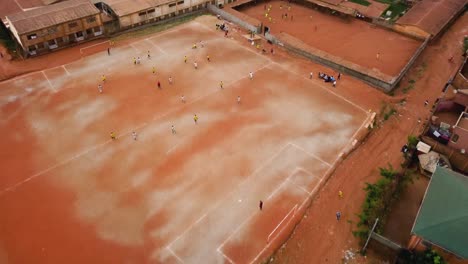 aerial view over an urban street soccer game in the city of yaounde, cameroon