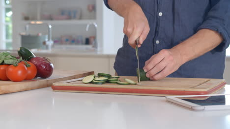 man follows recipe on digital tablet in kitchen shot on r3d