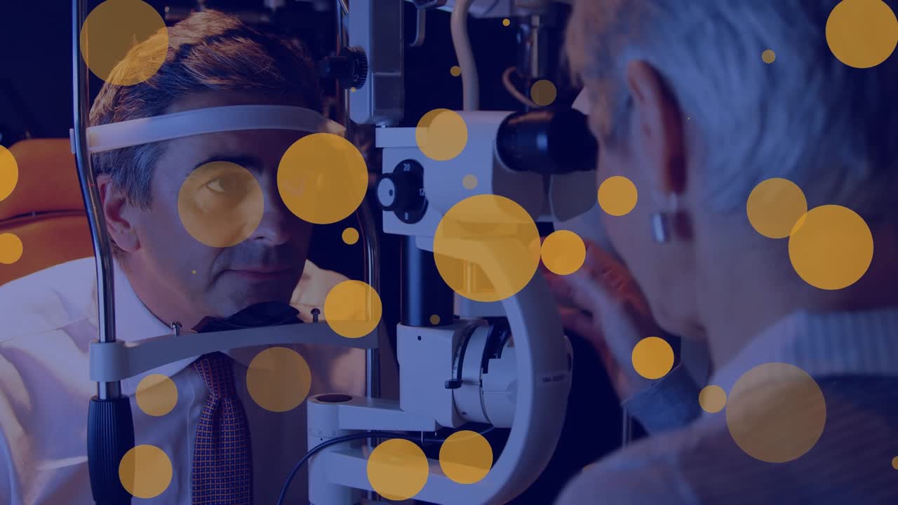 Animation of falling dots over caucasian eye doctor with patient