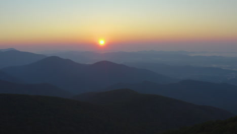 an aerial shot of the sunrise as seen from the summit of mt