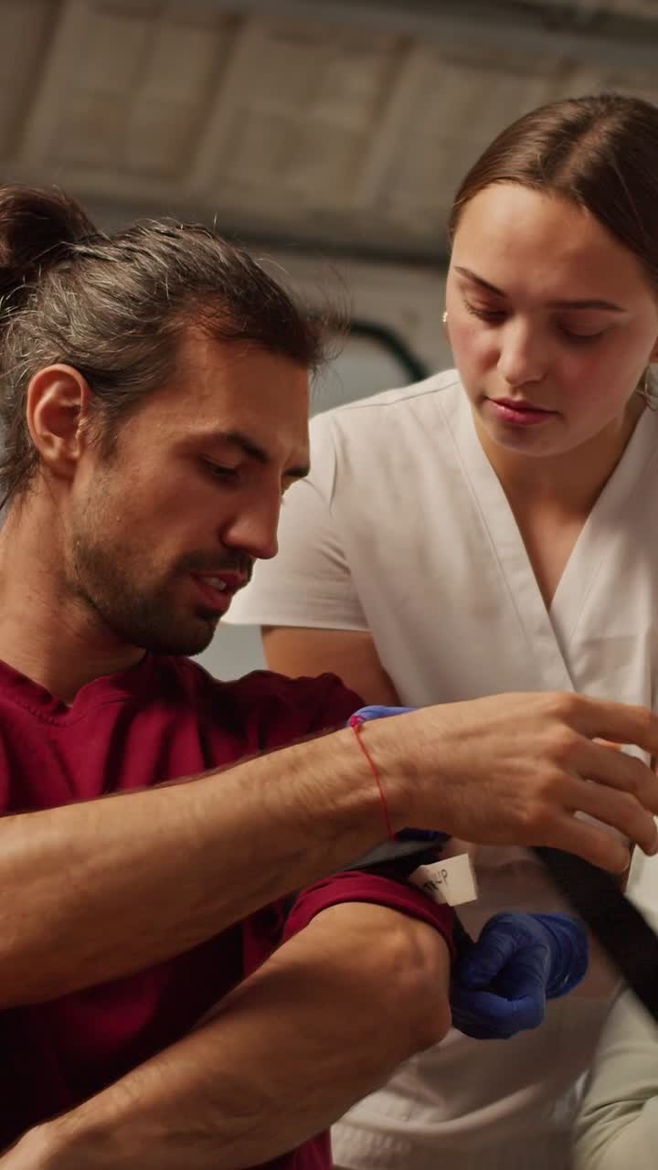Nurse Assisting Patient with Arm Injury