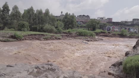 low angle drone shot over nairobi river in dandora kenya