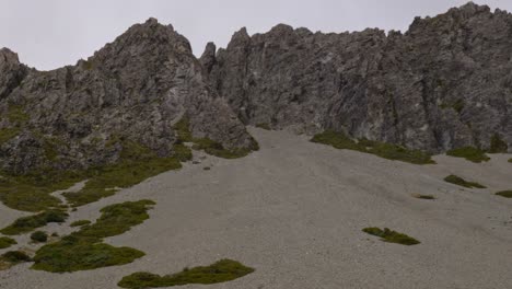 rocky mountains in red tarns track, aoraki, south island, new zealand - tilt up shot