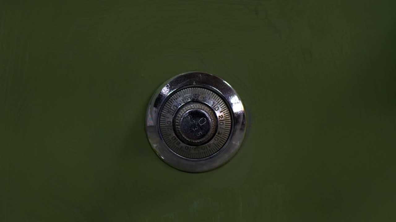 Closeup Of Vintage Combination Dial Lock On Green Metal Safe.