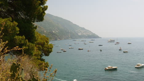 a wide shot of boats in the beautiful water of the italian mediterranean sea