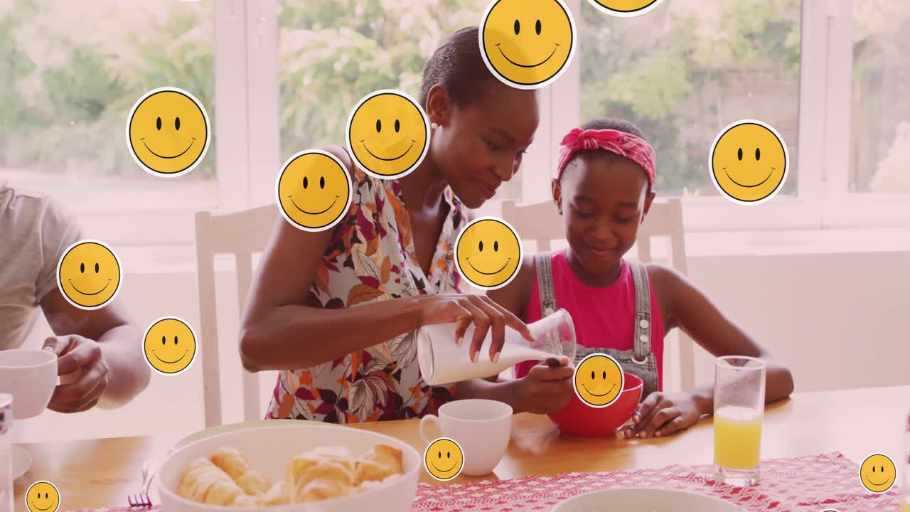 Pouring milk into cereal bowl, woman and child surrounded by smiley face animation