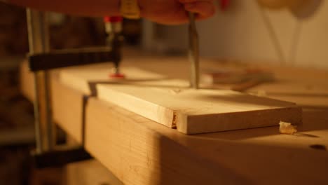 handheld dolly in of hand trying to separate cut pieces of wooden board