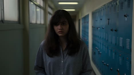 a woman standing in a school hallway