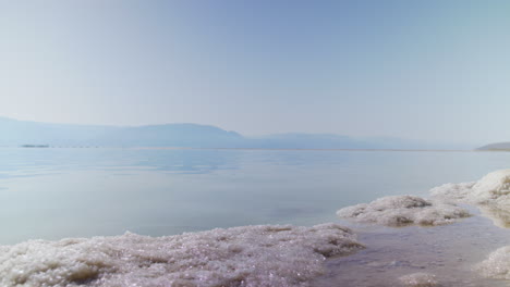 timelapse-of-slat-water-movement-of-the-Dead-Sea-in-the-early-morning---low-angle-with-salt-blocks-in-the-foreground