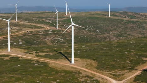 aerial establishing shot of a rural wind farm in the french countryside