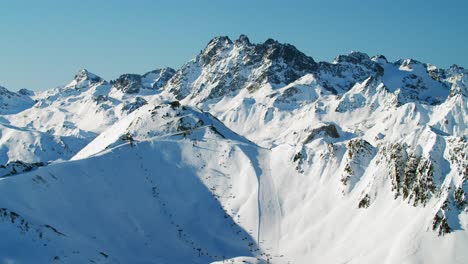 High-alpine-ski-resort-panorama-view-with-big-ski-slopes-and-moder-ski-lifts-in-the-austrian-alps