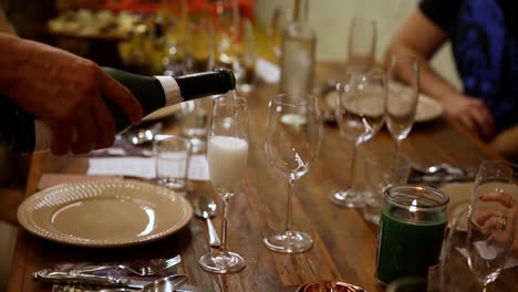 pouring white wine or champagne at a formal dinner party - isolated slow motion