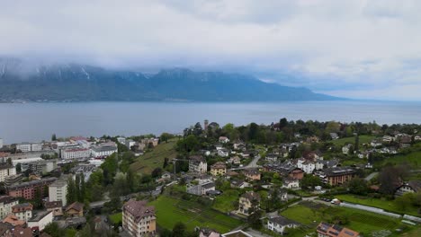 flying over montreux city in switzerland on a stormy looking day with lake geneva and alps in the background