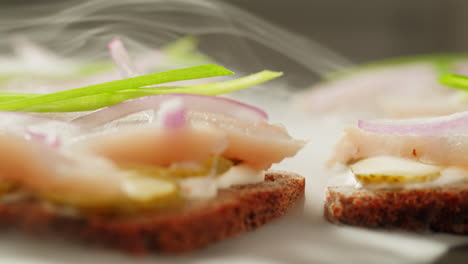 smoked fish sandwiches with dill, cream cheese, and onions