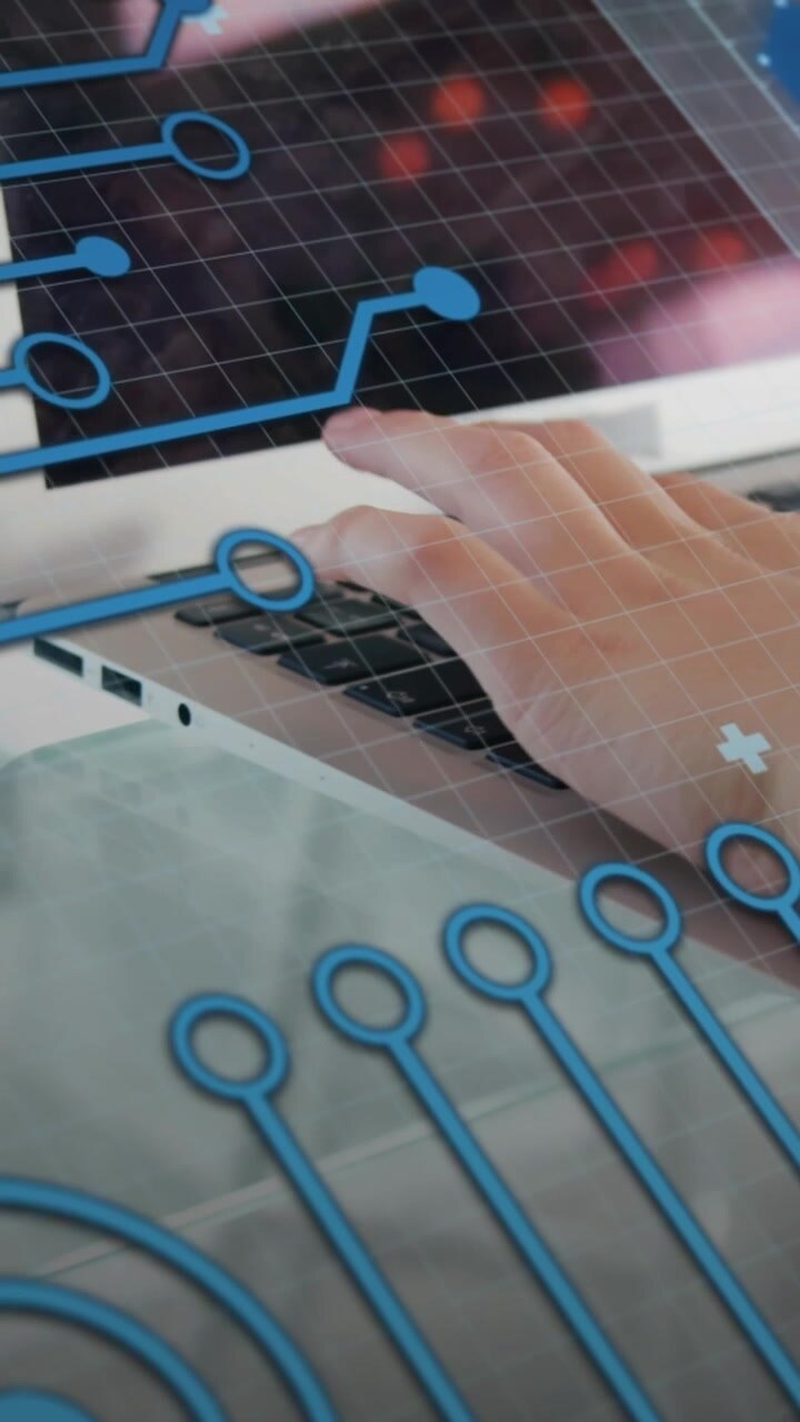 Animation of graphs and circuit board pattern over coffee cup and caucasian woman working on laptop