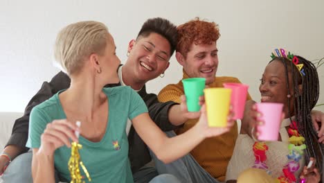 diverse friends celebrating a birthday party with colorful cups