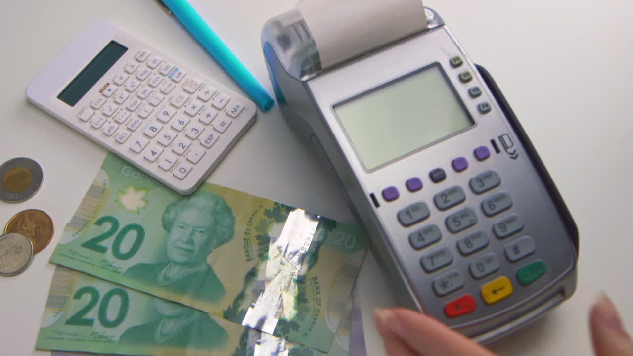 A woman's hand swipes a card into a debit machine