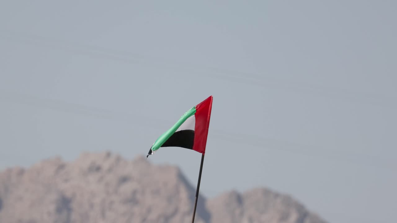 Close shot United Arab Emirates flag in slowmotion in city Hatta