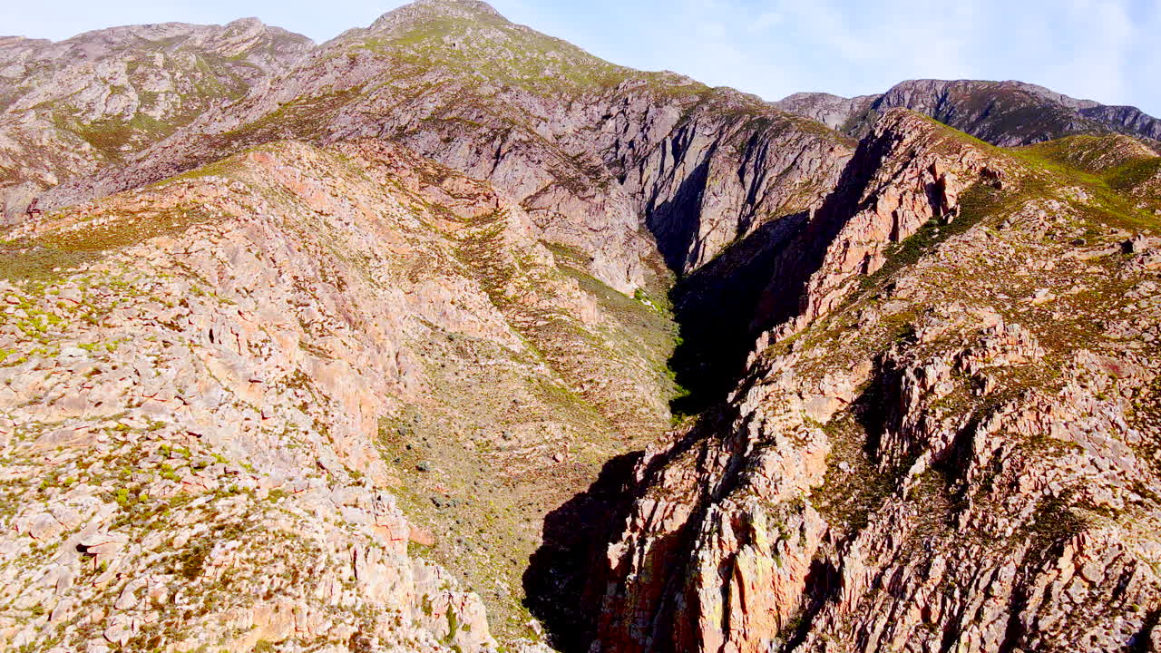 Aerial dolly toward gorge of rugged Langeberg mountains in Montagu, Klein Karoo