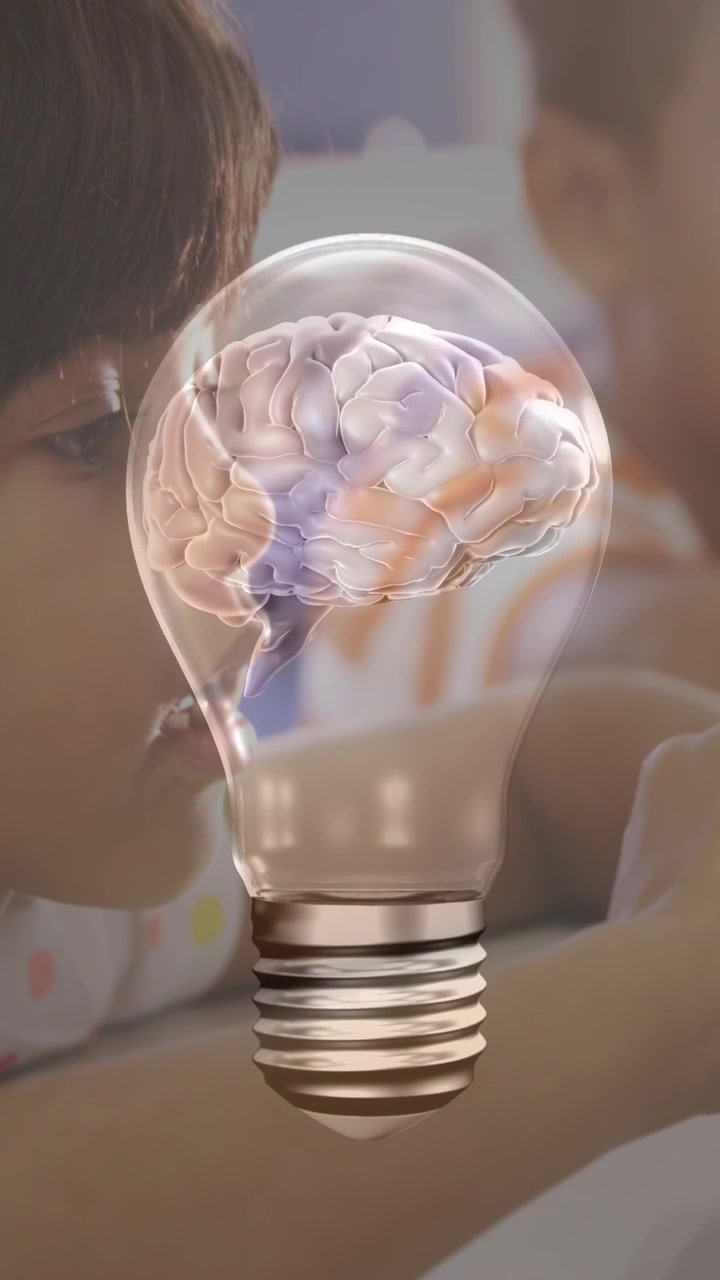 Vertical video: Lightbulb graphic appearing, girl tracking rotating brain for classroom learning