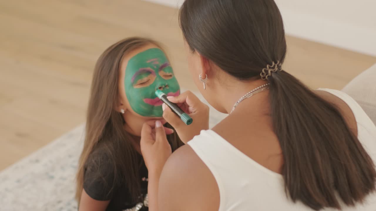 Little Girl Getting Face Painted for Halloween