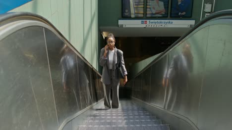 businesswoman using escalator at metro station