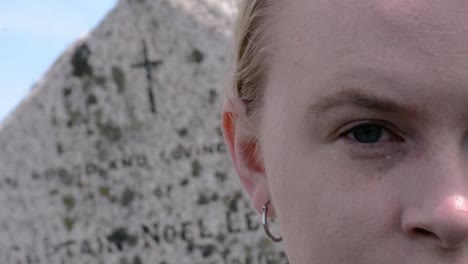 Extreme-Close-Up-Rack-Focus-Shot-of-Old-Tombstone-and-Girl�s-Right-Eye-Blinking