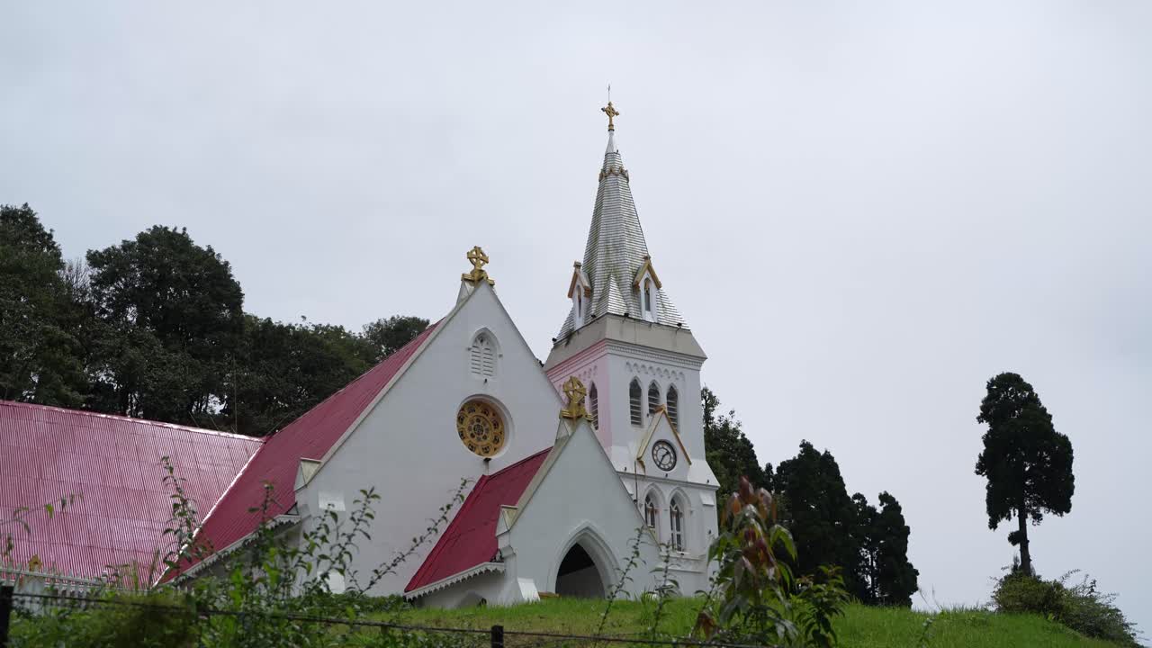 There is a church on the top of the mountain. It is located in Darjeeling