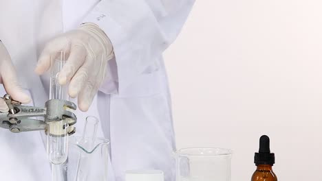 a scientist prepares a test tube and beaker in a laboratory setting, focusing on precise handling.