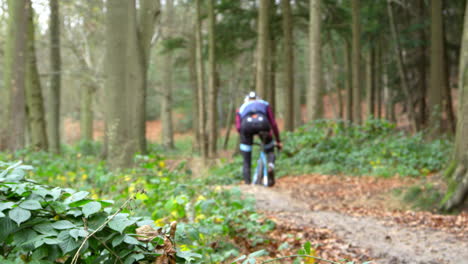 man cross-country cycling  splashes through a puddle, shot on r3d