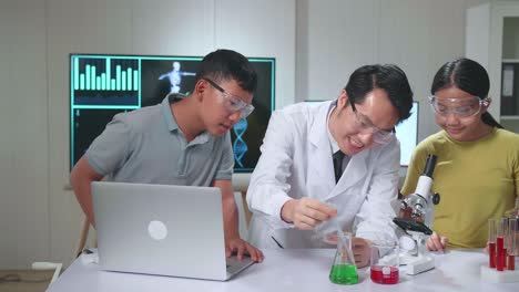 young asian boy and girl learning science experiment in laboratory with teacher in classroom. study with scientific equipment and a microscope